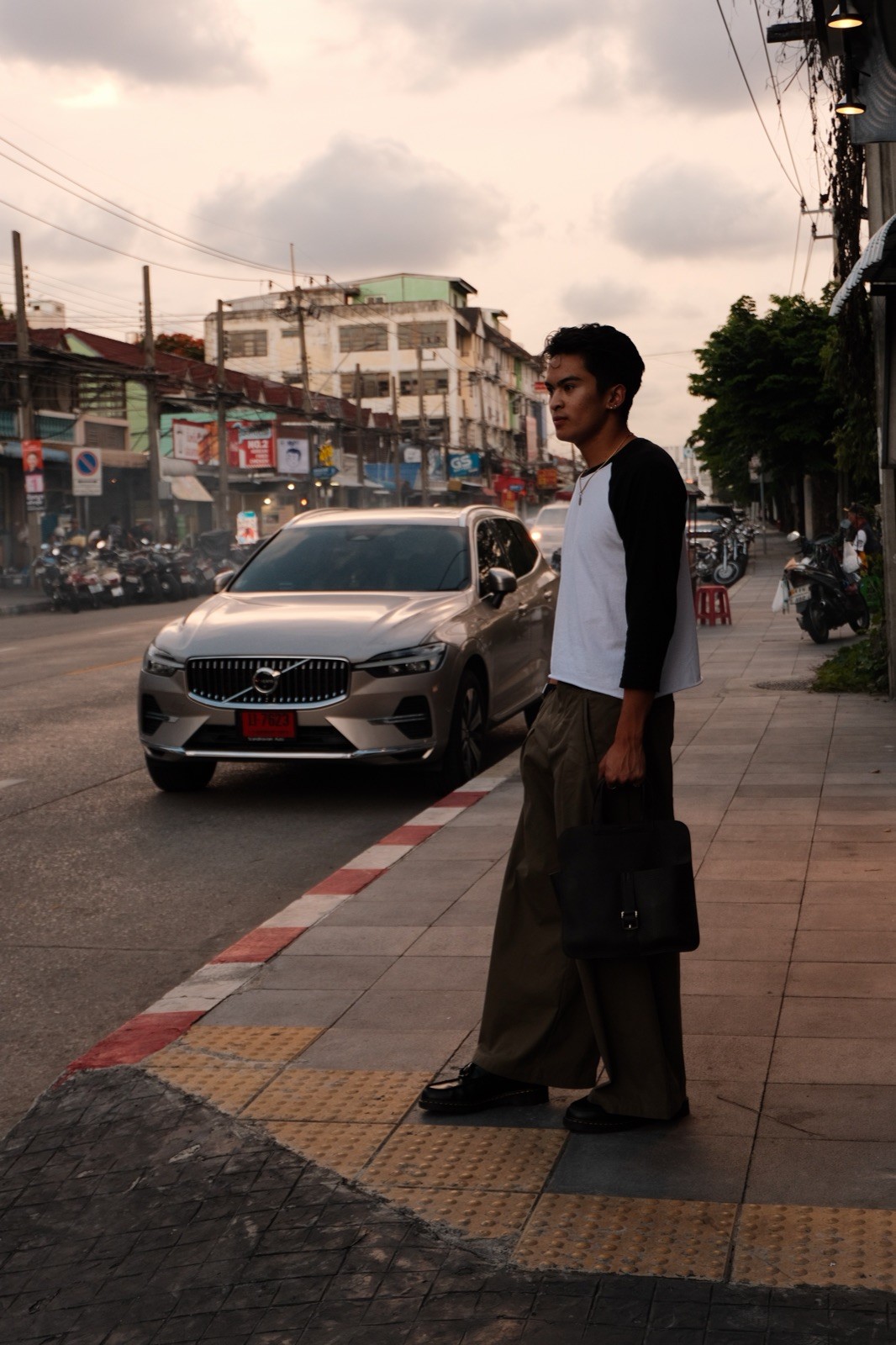 Ratanon on a Bangkok sidewalk at dusk