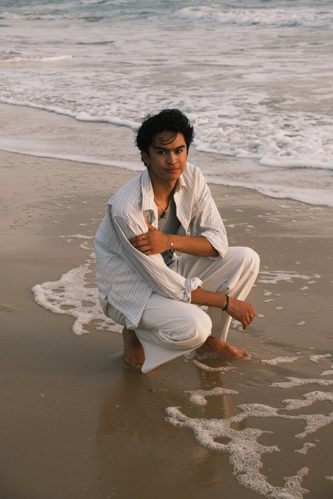 Ratanon crouched at the shoreline