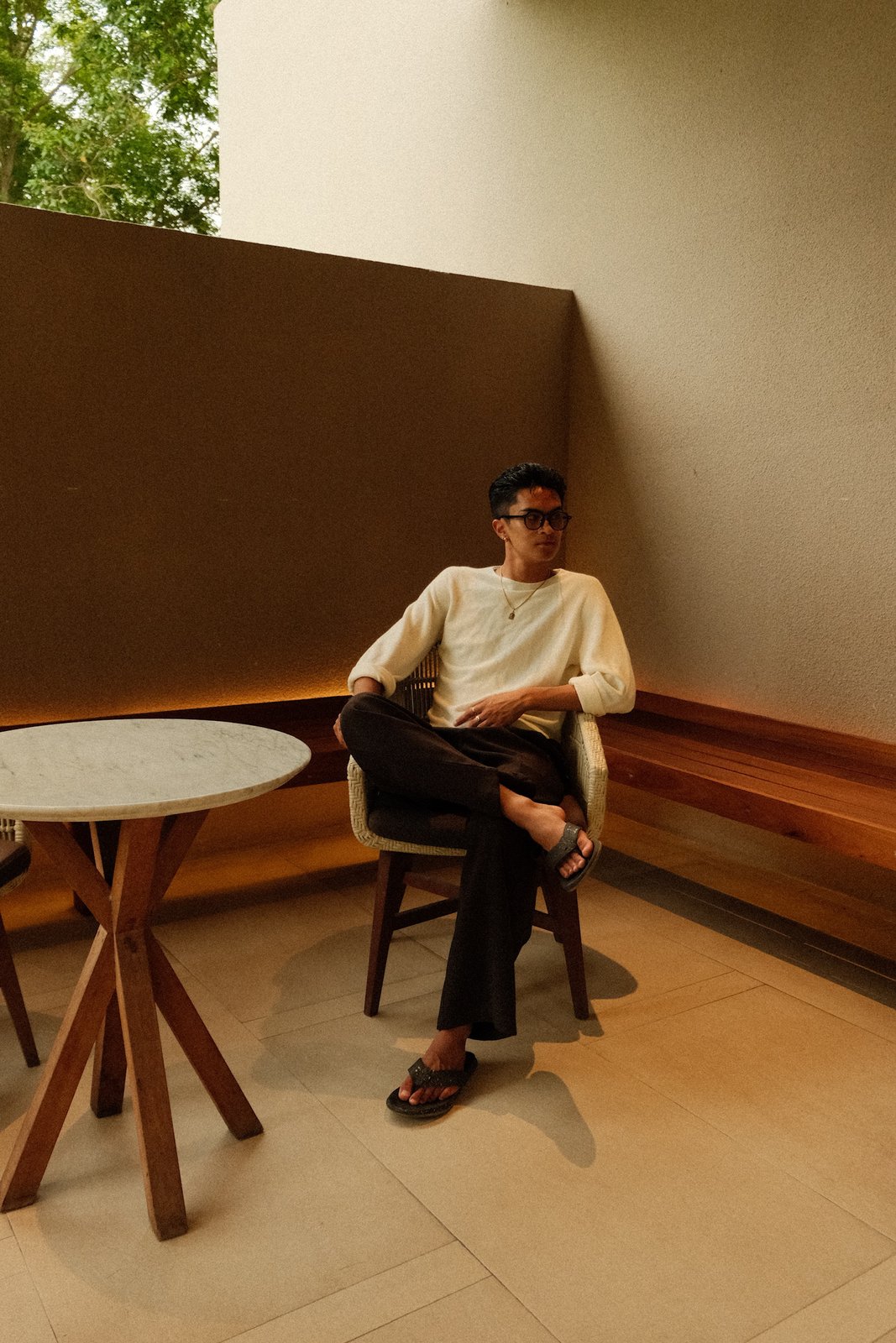 Ratanon seated at an outdoor table