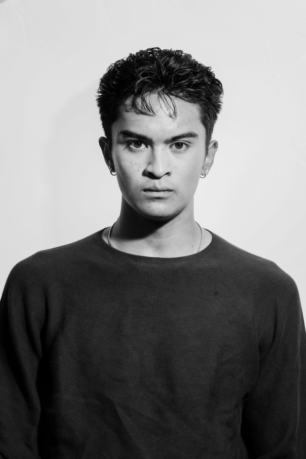 Ratanon, black and white studio portrait, arms crossed