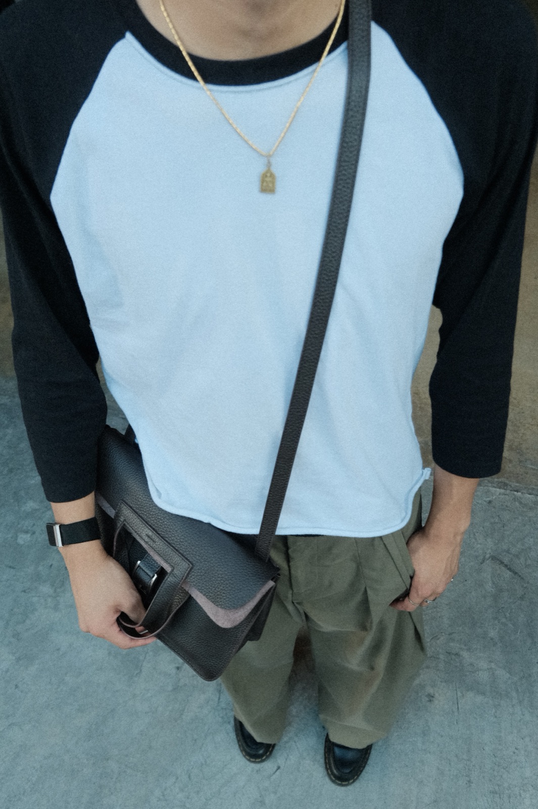 Detail shot of layered necklaces and a crossbody bag